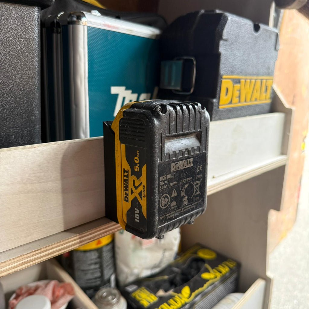 DeWalt 5.0Ah battery clipped into a VanMount holder on a van rack