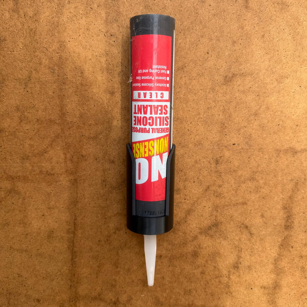 Sealant cartridge holder mounted to a board
