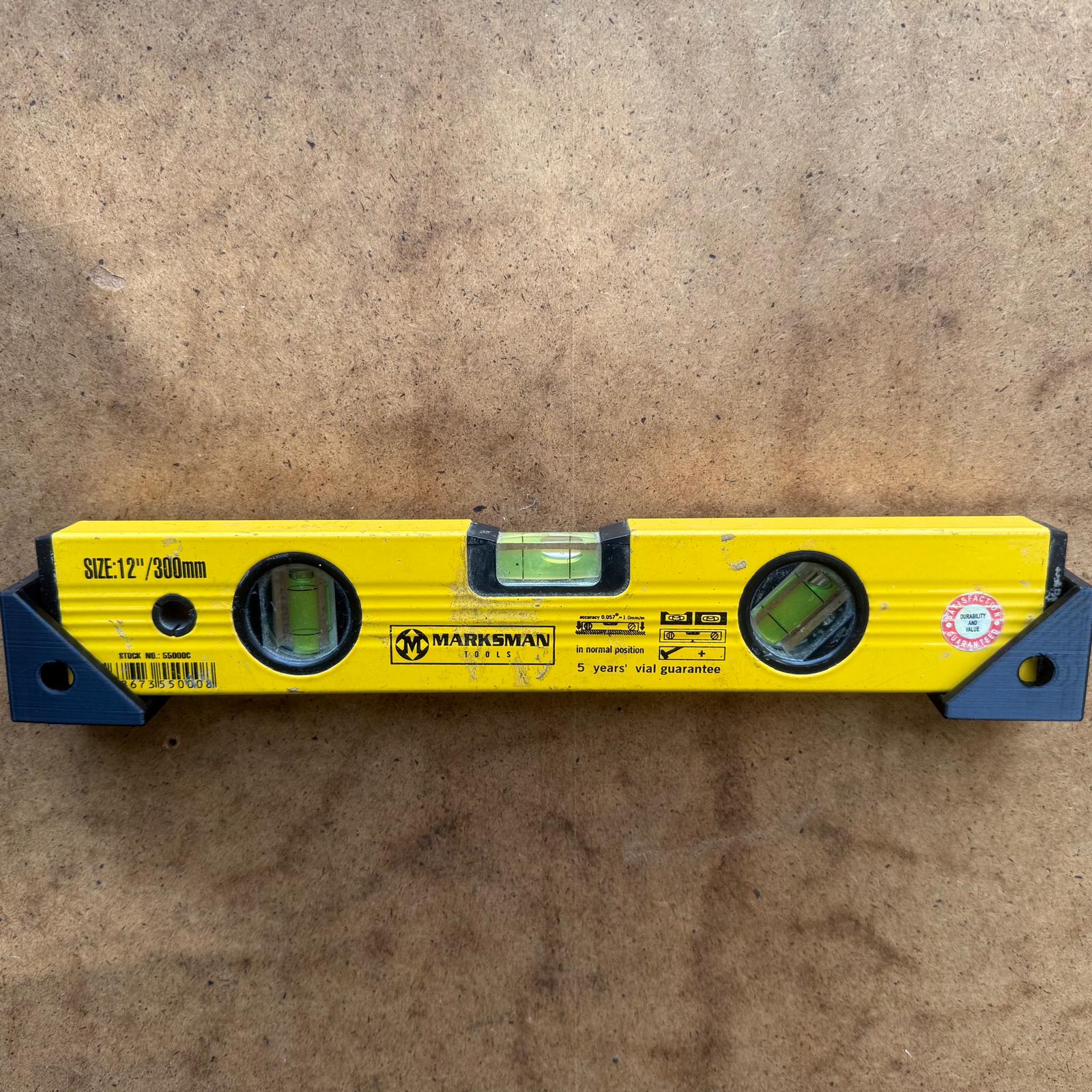 Spirit level held on a board by a pair of VanMount cradle brackets